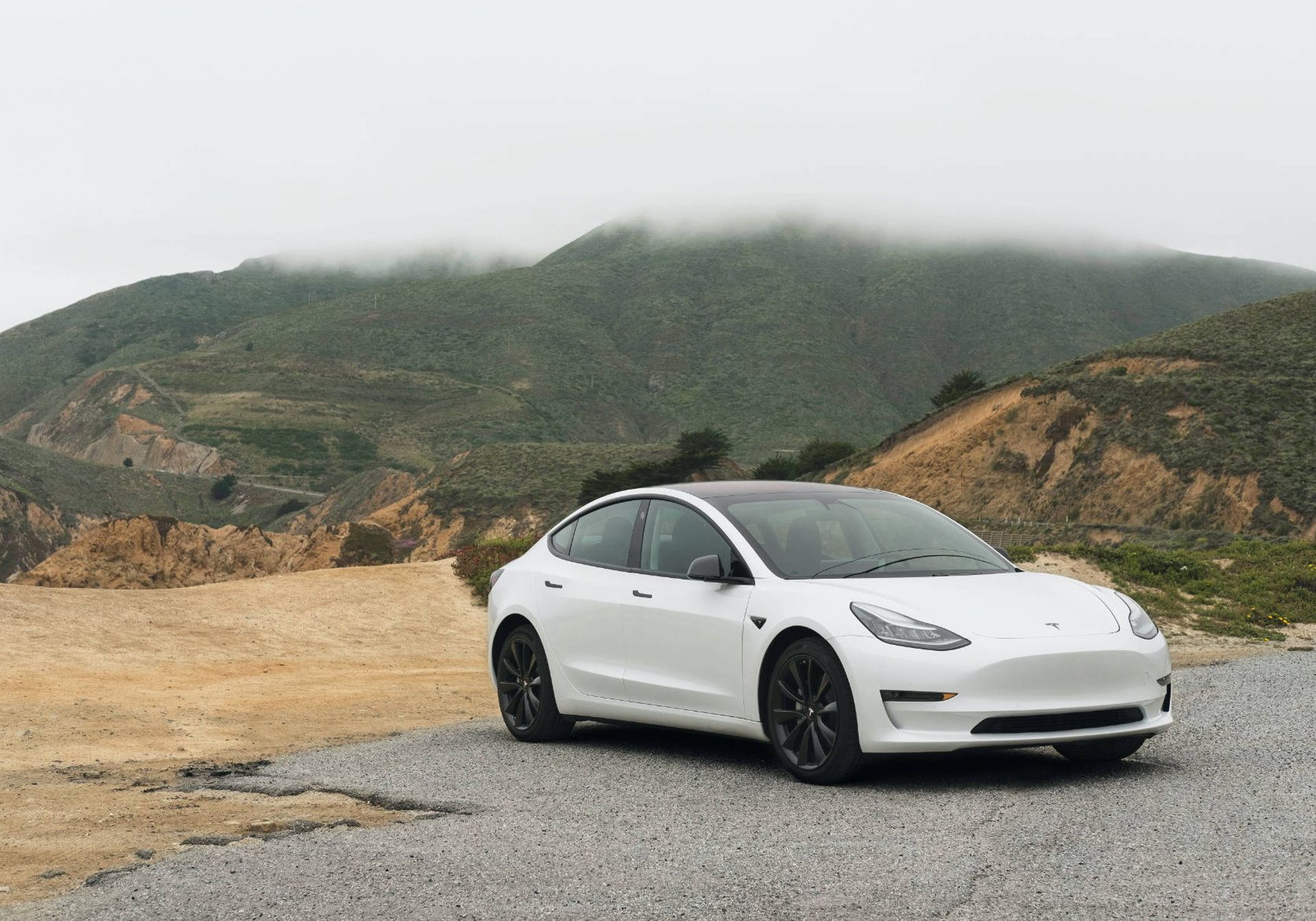white tesla in the mountains