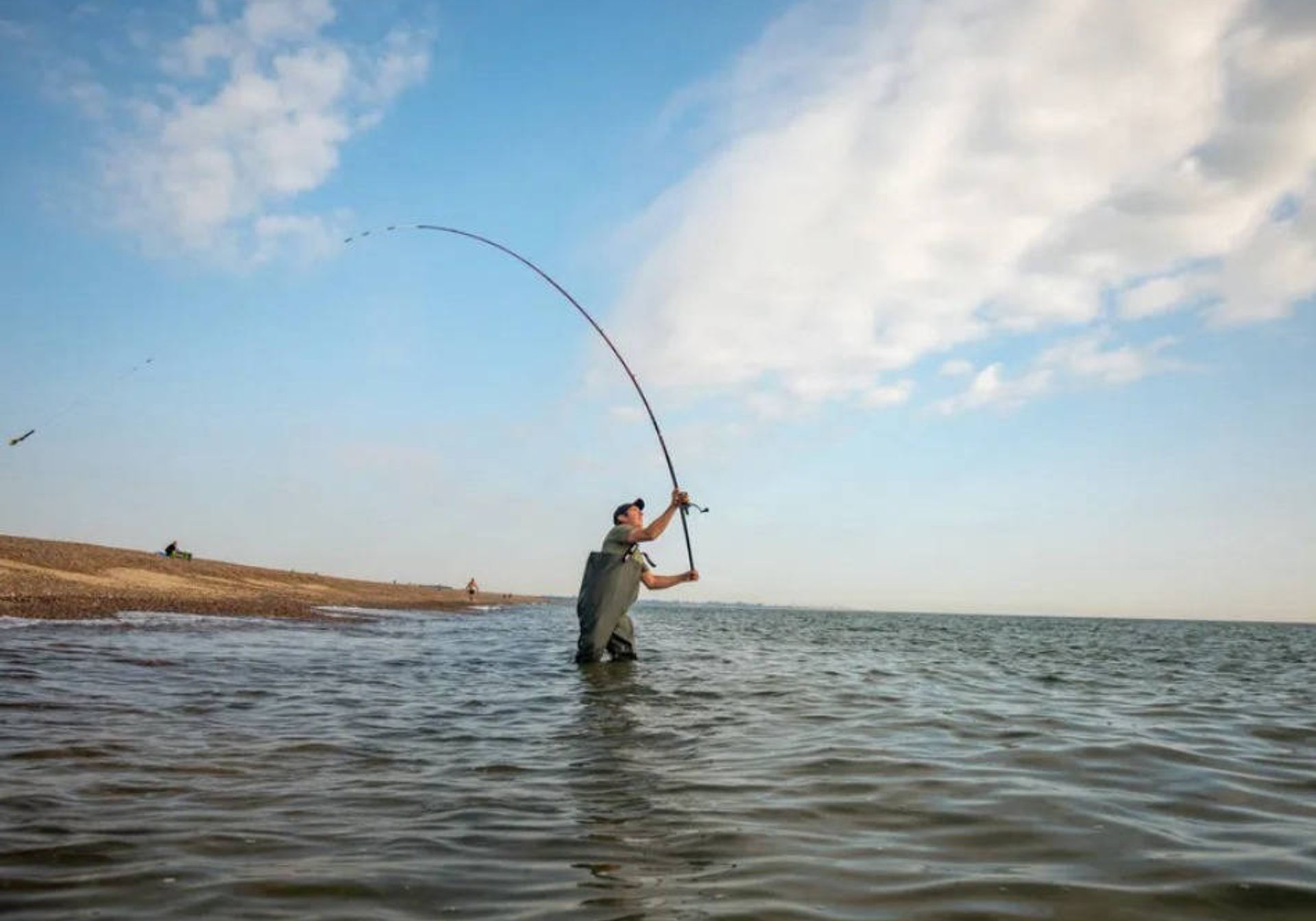Man sea fishing, casting his line