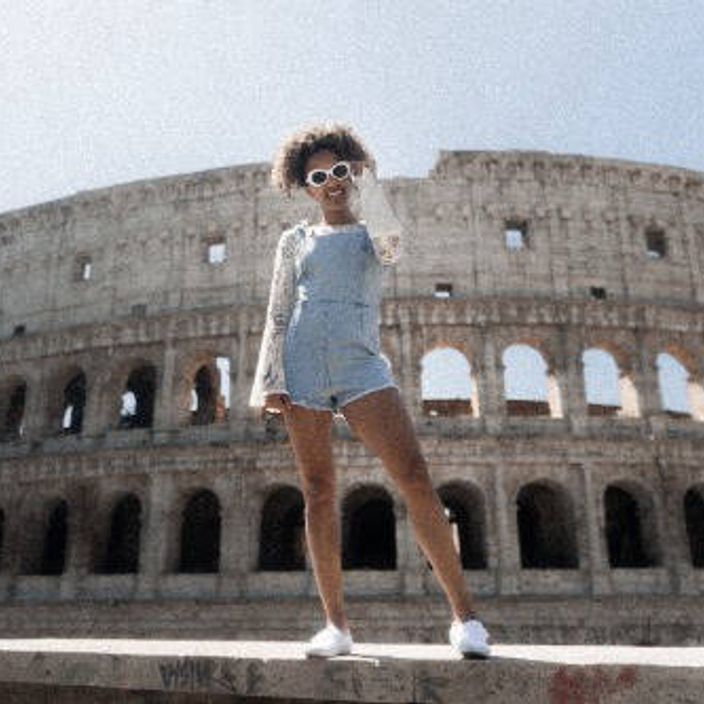 happy girl in front of the colosseum in rome