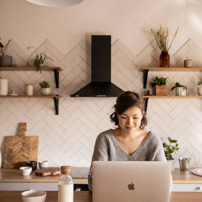 Woman working on laptop at table