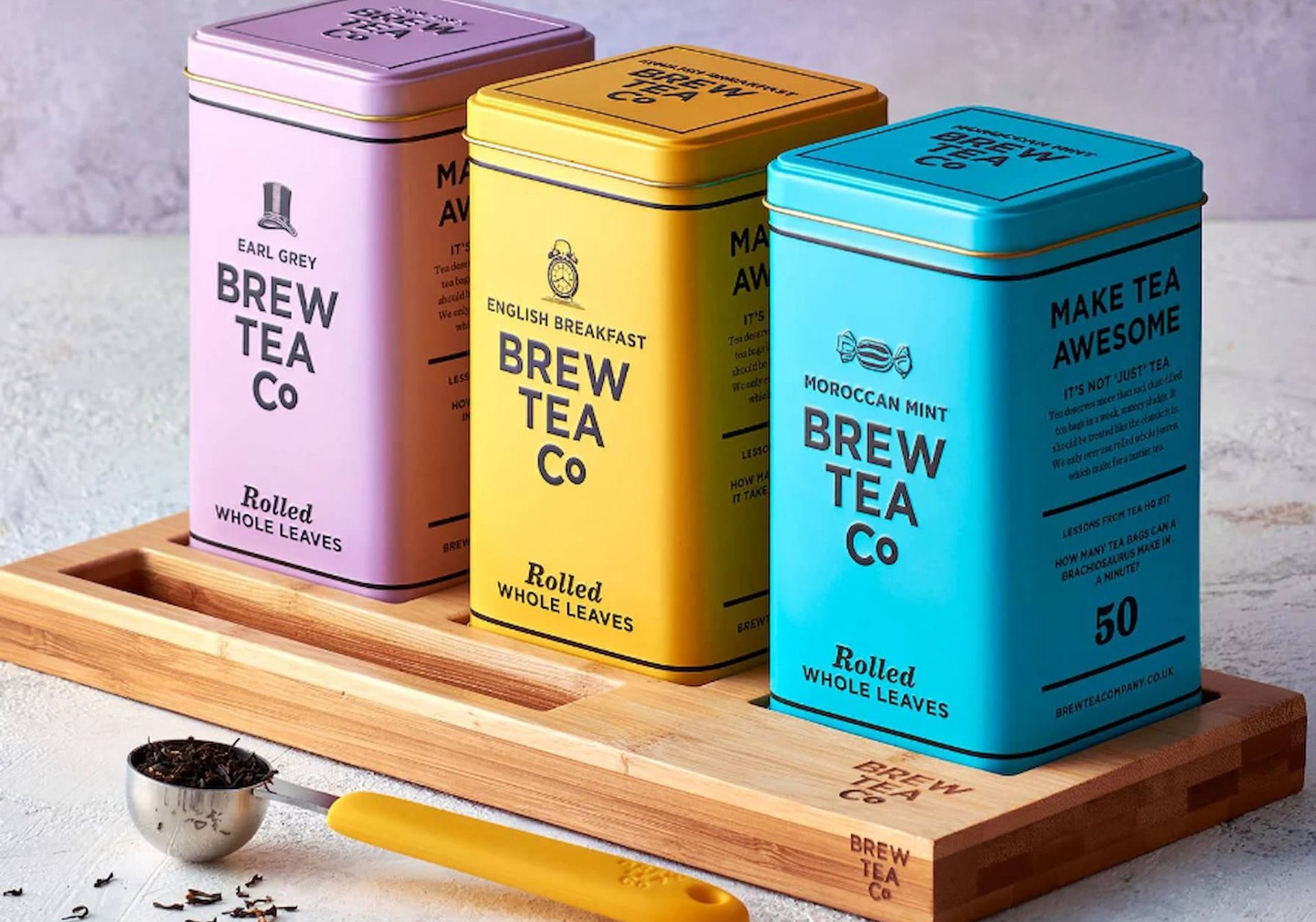 Brew Tea Co tea tins in purple, yellow and blue