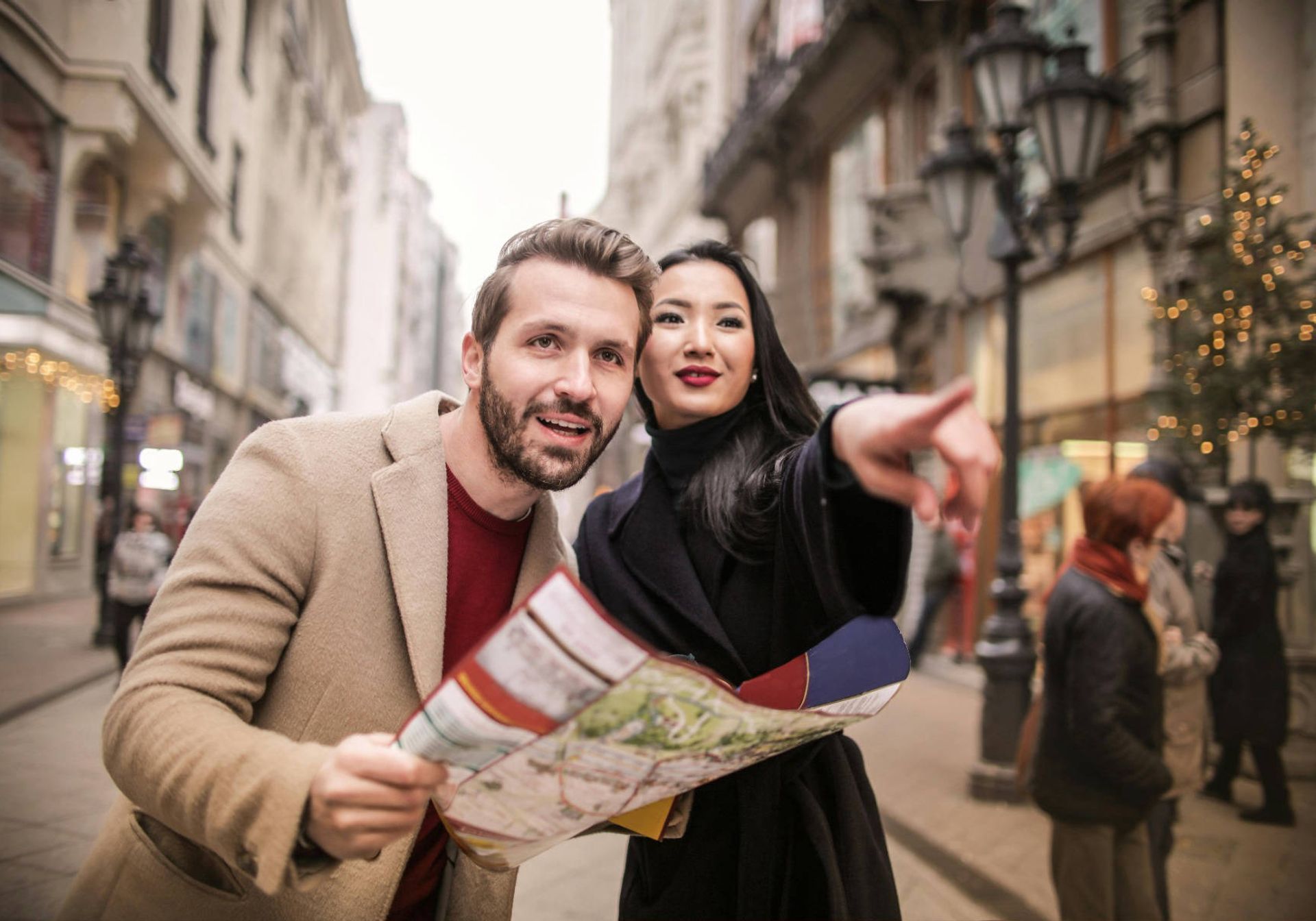 Man and a woman consulting a map. Woman pointing out 