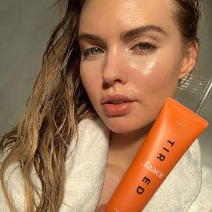 woman holding a tired Faace mask