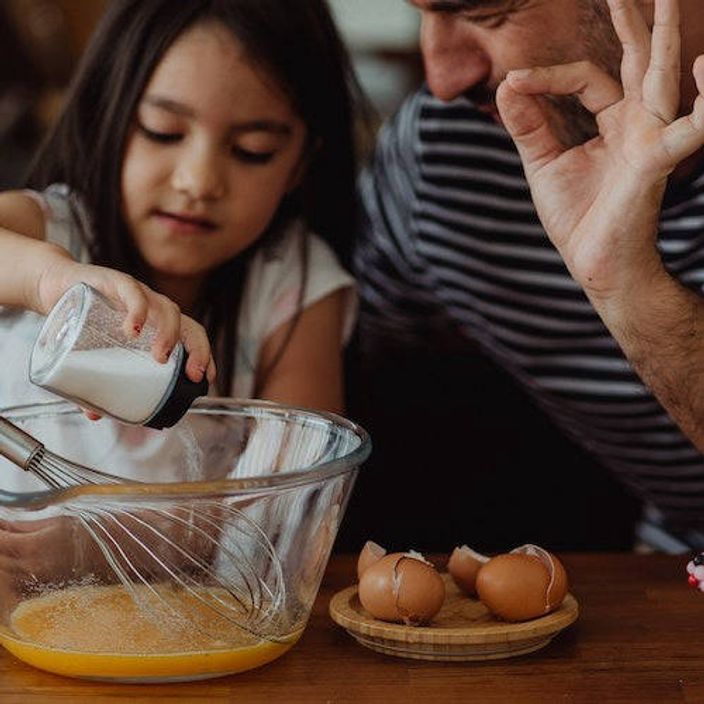 A father and daughter baking
