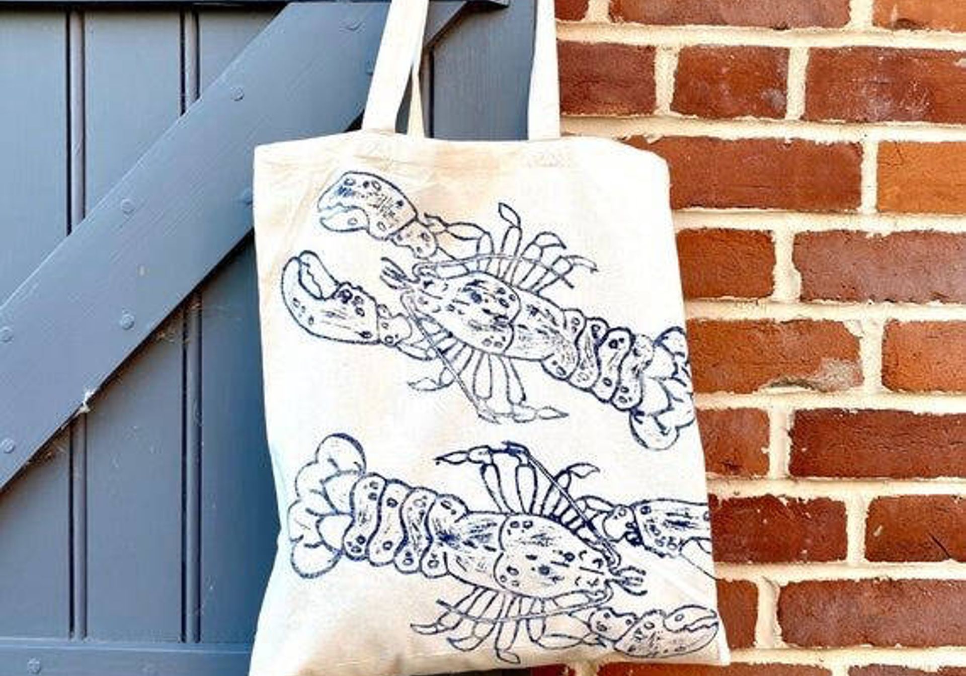 Natural cotton tote bag with blue lobster linocut print