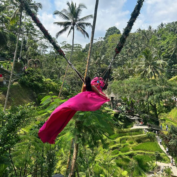 a black woman on a swing in Bali