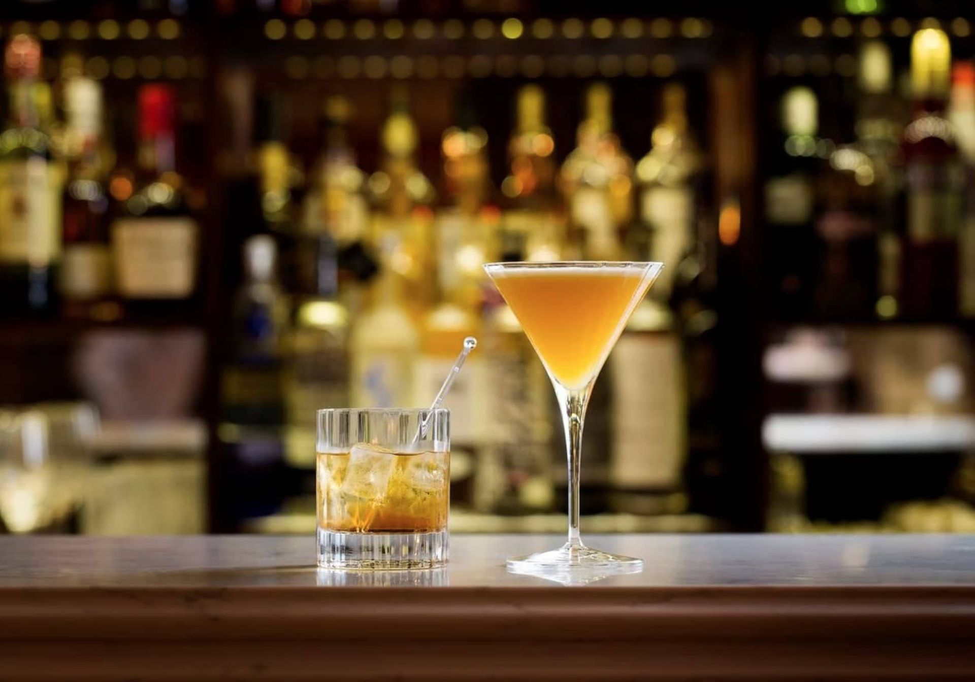 Two cocktails on a bar 