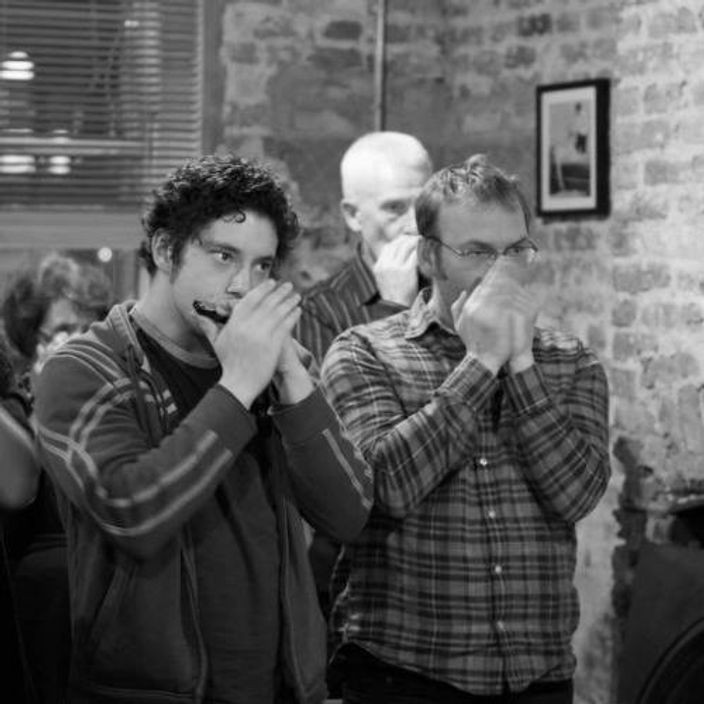 Group of people playing the harmonica