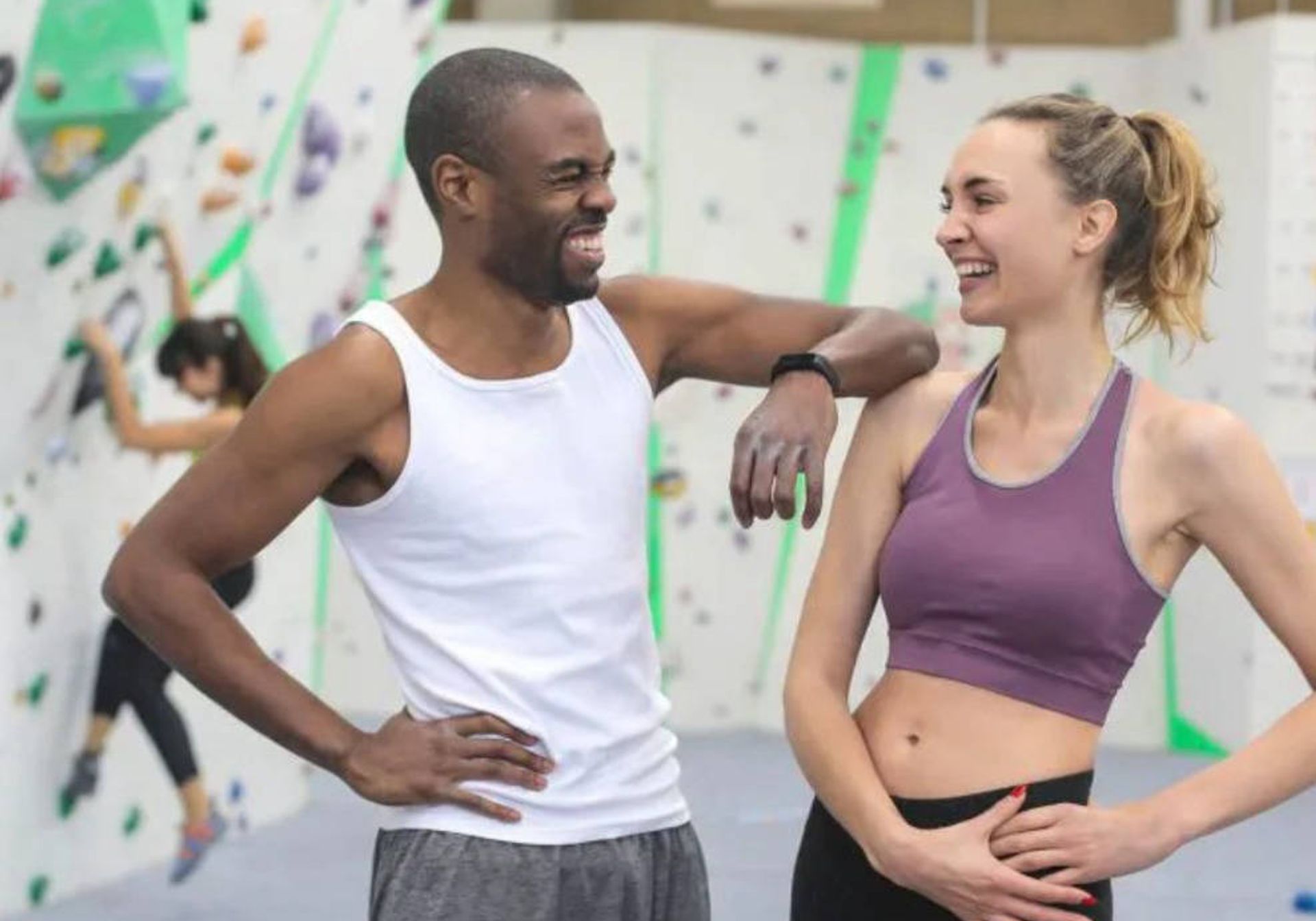 Two climbers chatting in a climbing centre