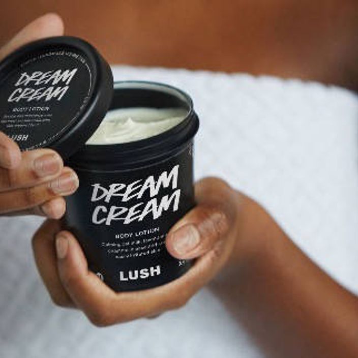 woman holding pot of dream cream