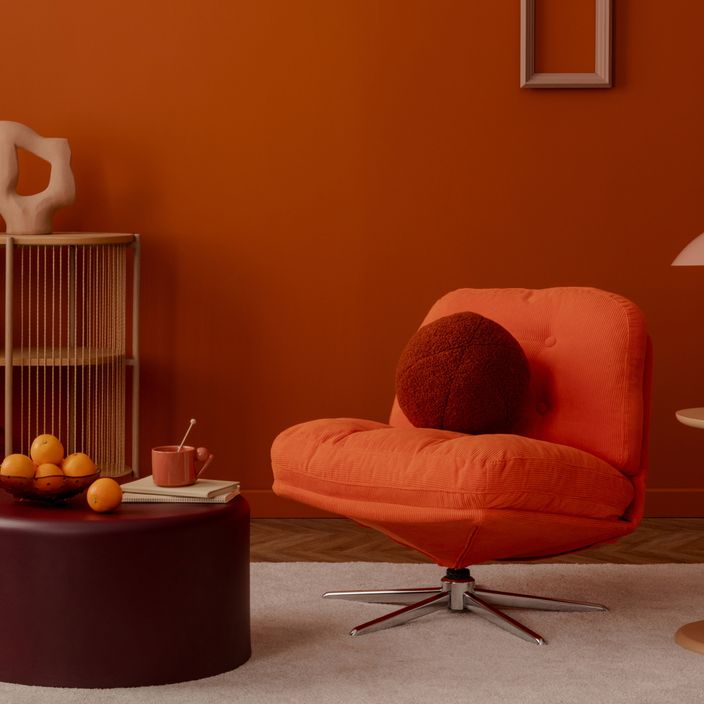 Orange chair in a cozy autumnal room
