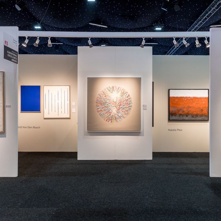 Paintings hung on the wall of an art gallery