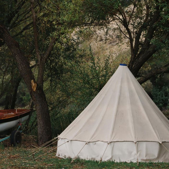 A family of 4 roasting marshmallows at a camp fire