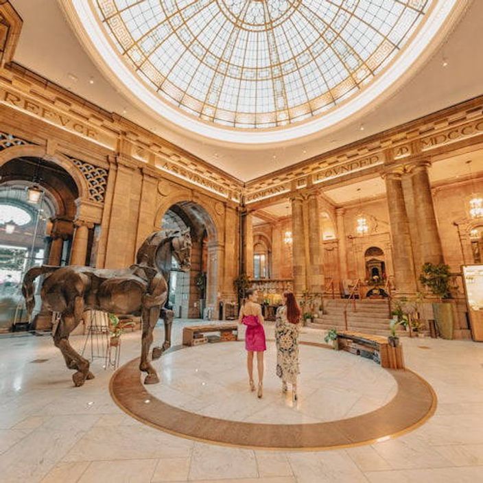 Two women in the lobby of Kimpton Clocktower Hotel