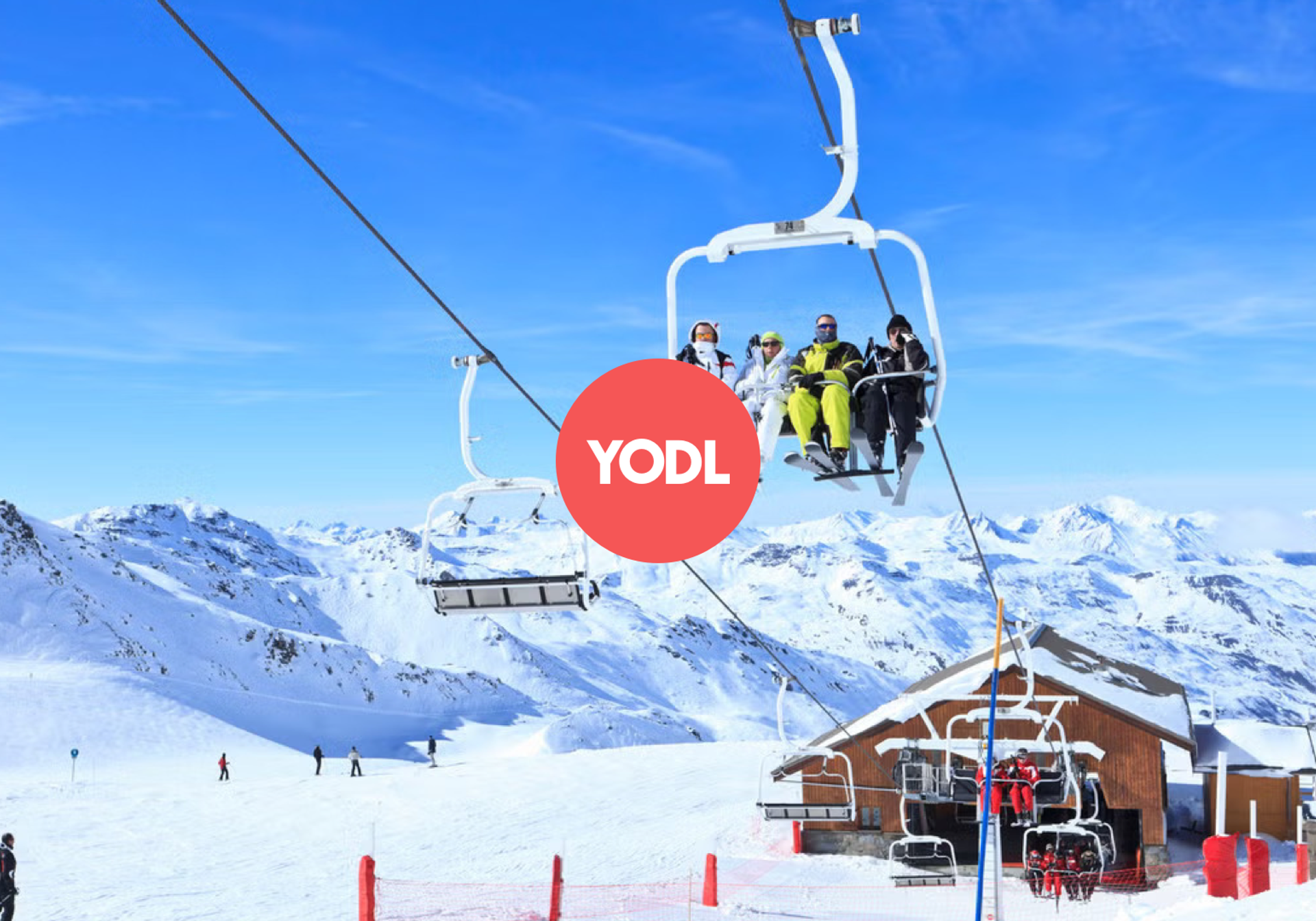 a lot of people in skiing gear standing on a slope with a chalet in the backdrop, a logo of the company 'SkiYodl' is centred in the picture