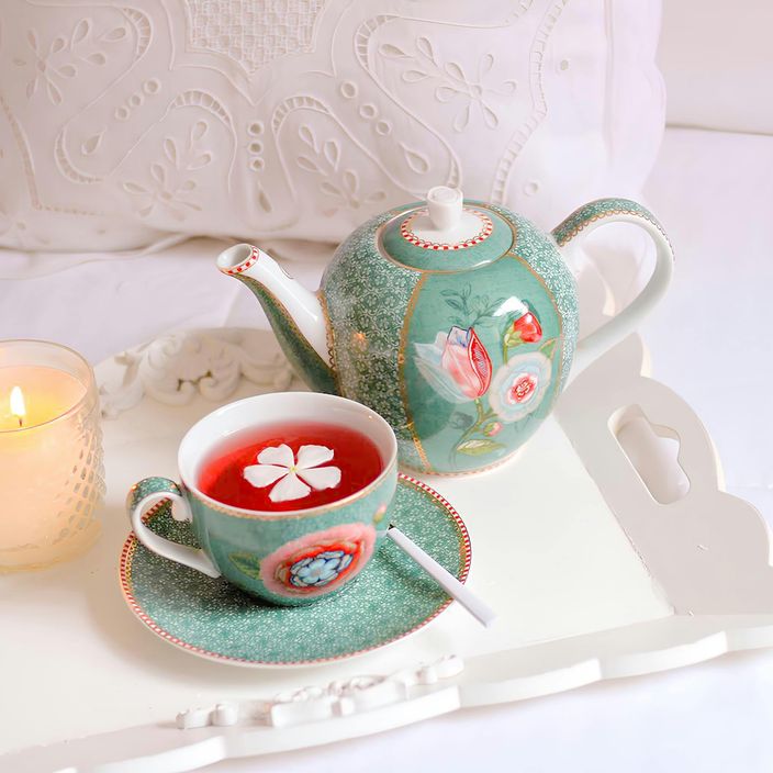 Candle on a table with plants