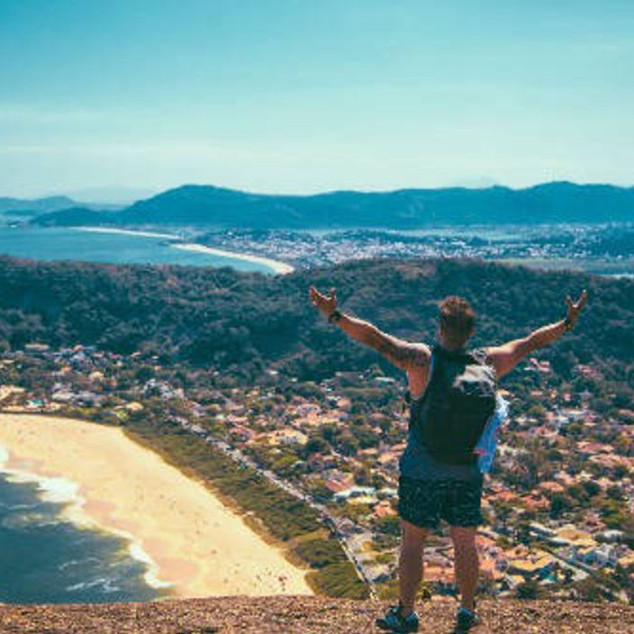 happy man overlooking the sea shore