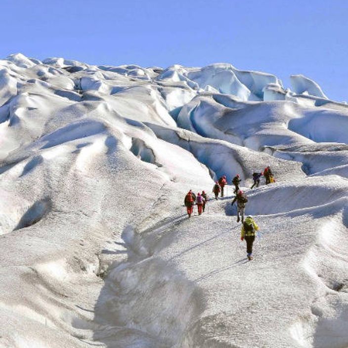 people hiking glacier in greenland