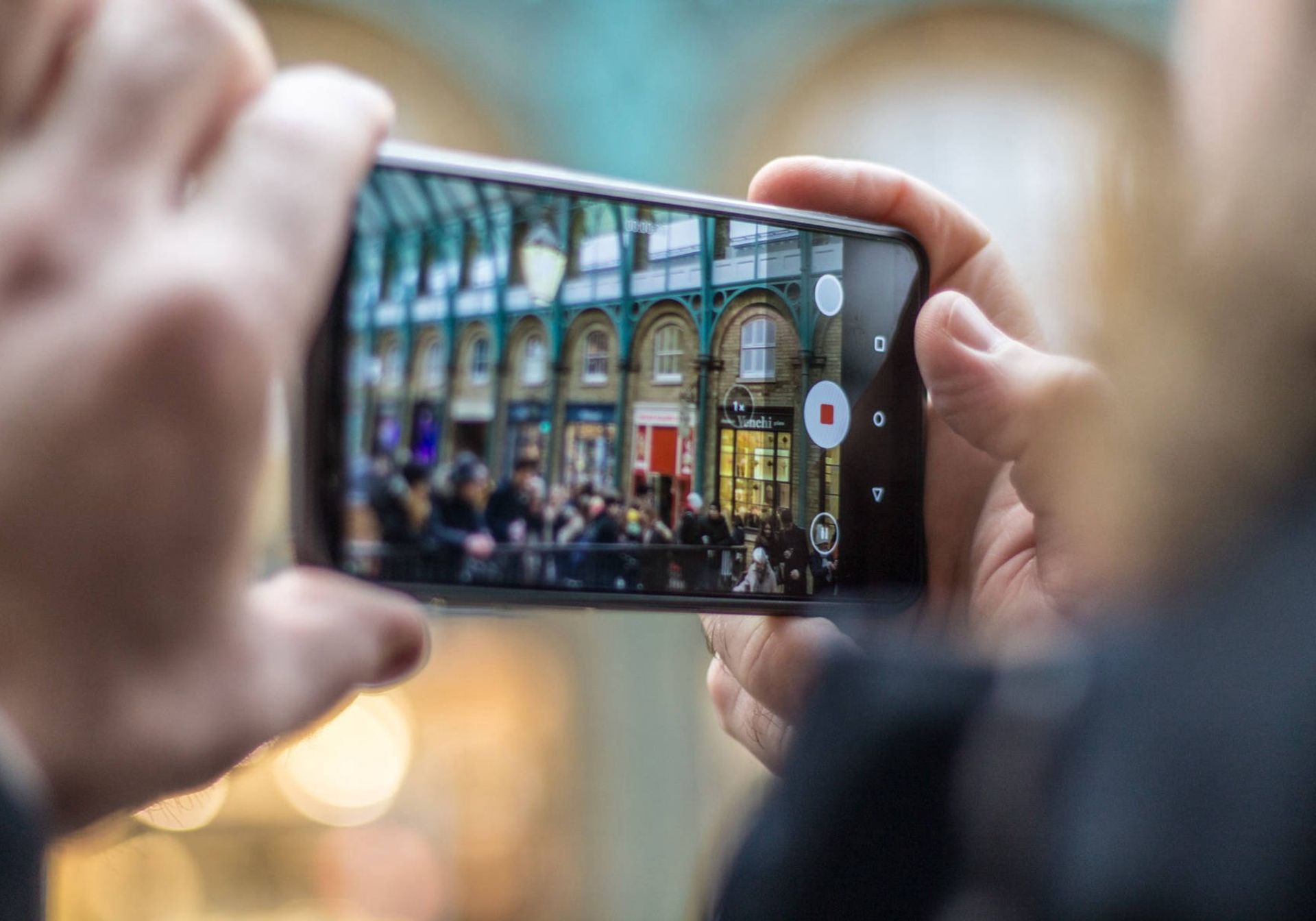 Man taking picture with iPhone in London