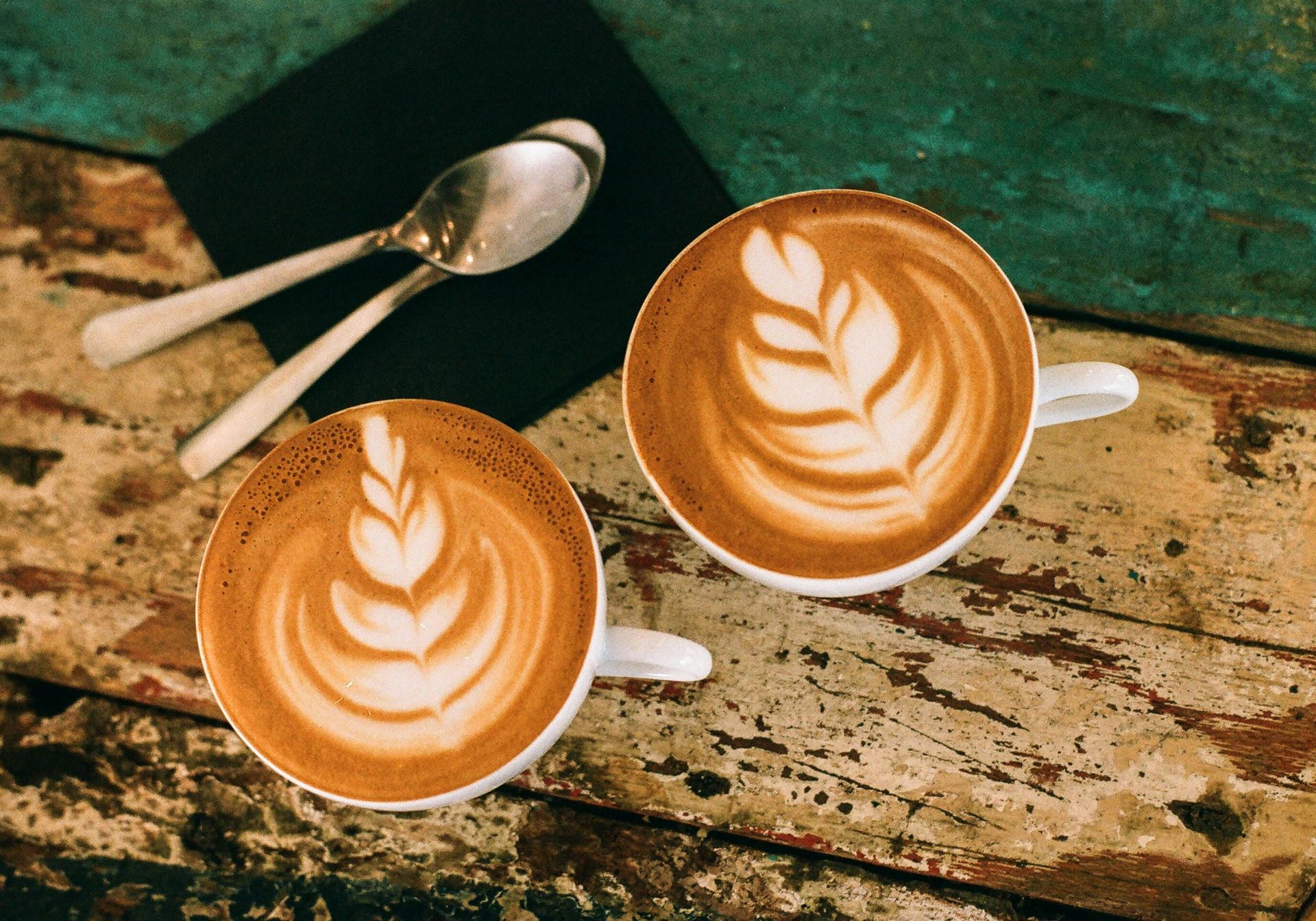 Two coffee cups with coffee art