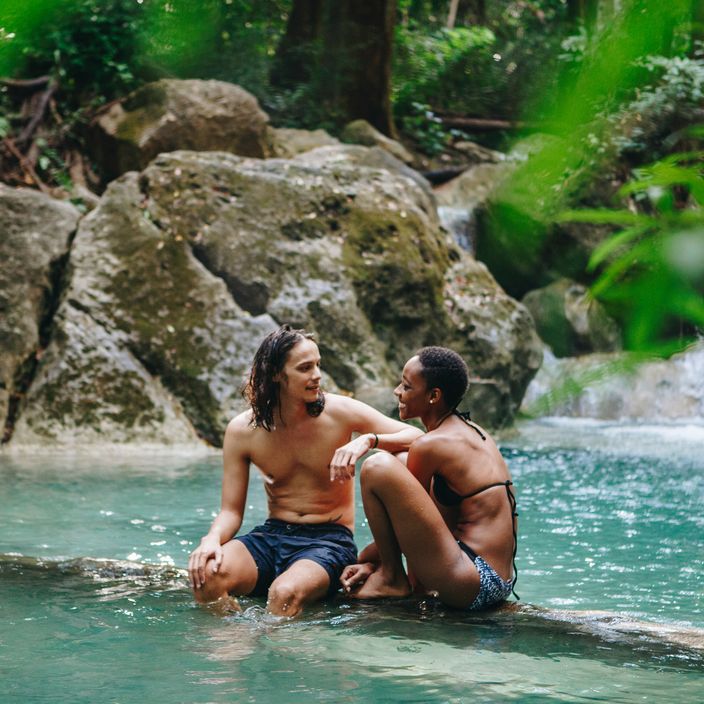 Couple exploring a waterfall