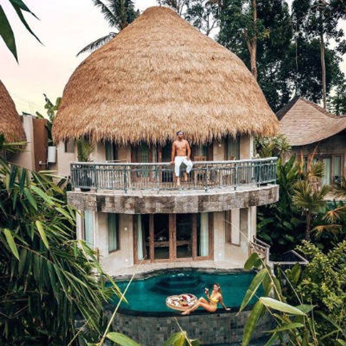 guy standing on balcony of luxury cottage in udaya resort