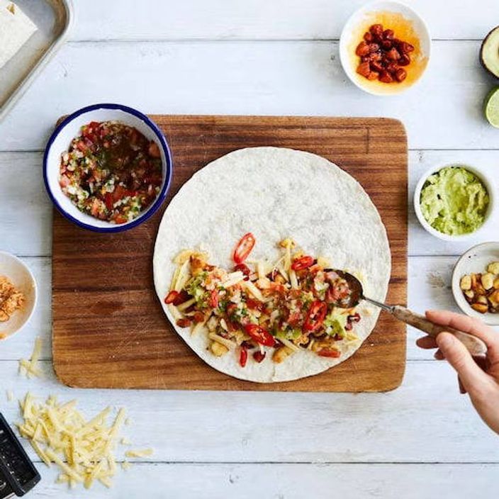 Person cooking fajita style wraps