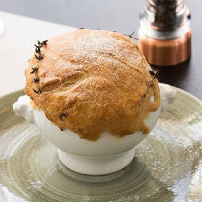 a french onion soup made by Jean-Christophe Novelli covered in bread