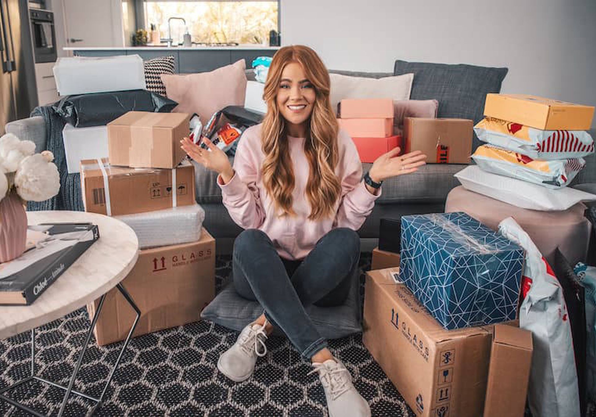 Woman surrounded by boxes and gifts