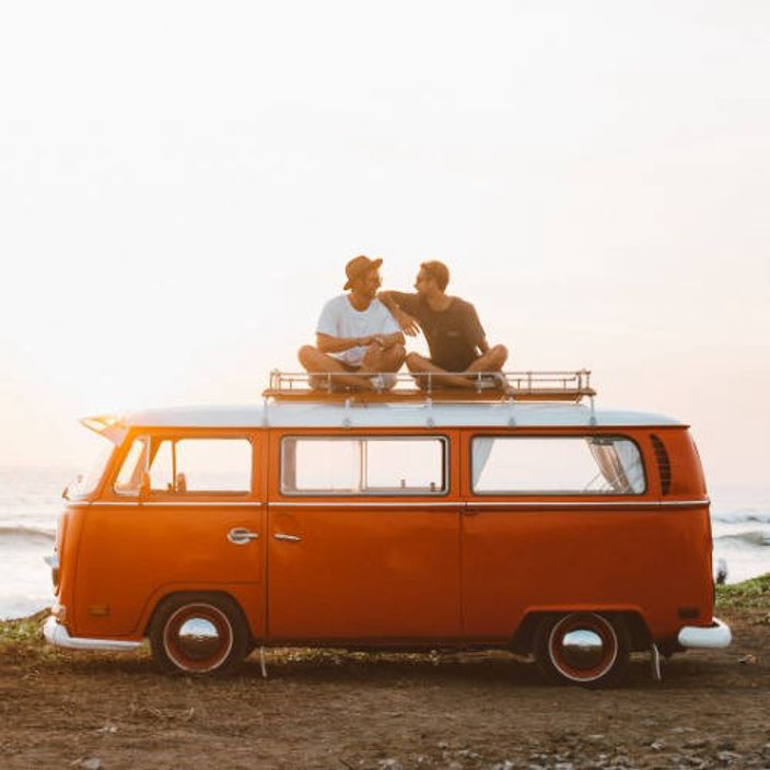 Two men sat on top of a VW Campervan