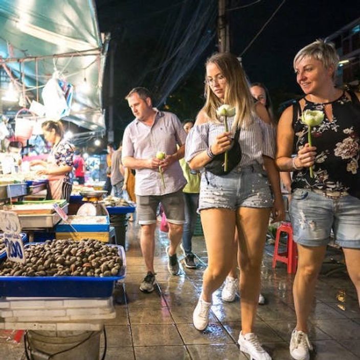 Couple walking through a street food market
