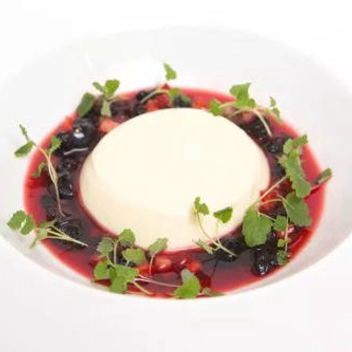 a cheese cake desert surrounded with red berries