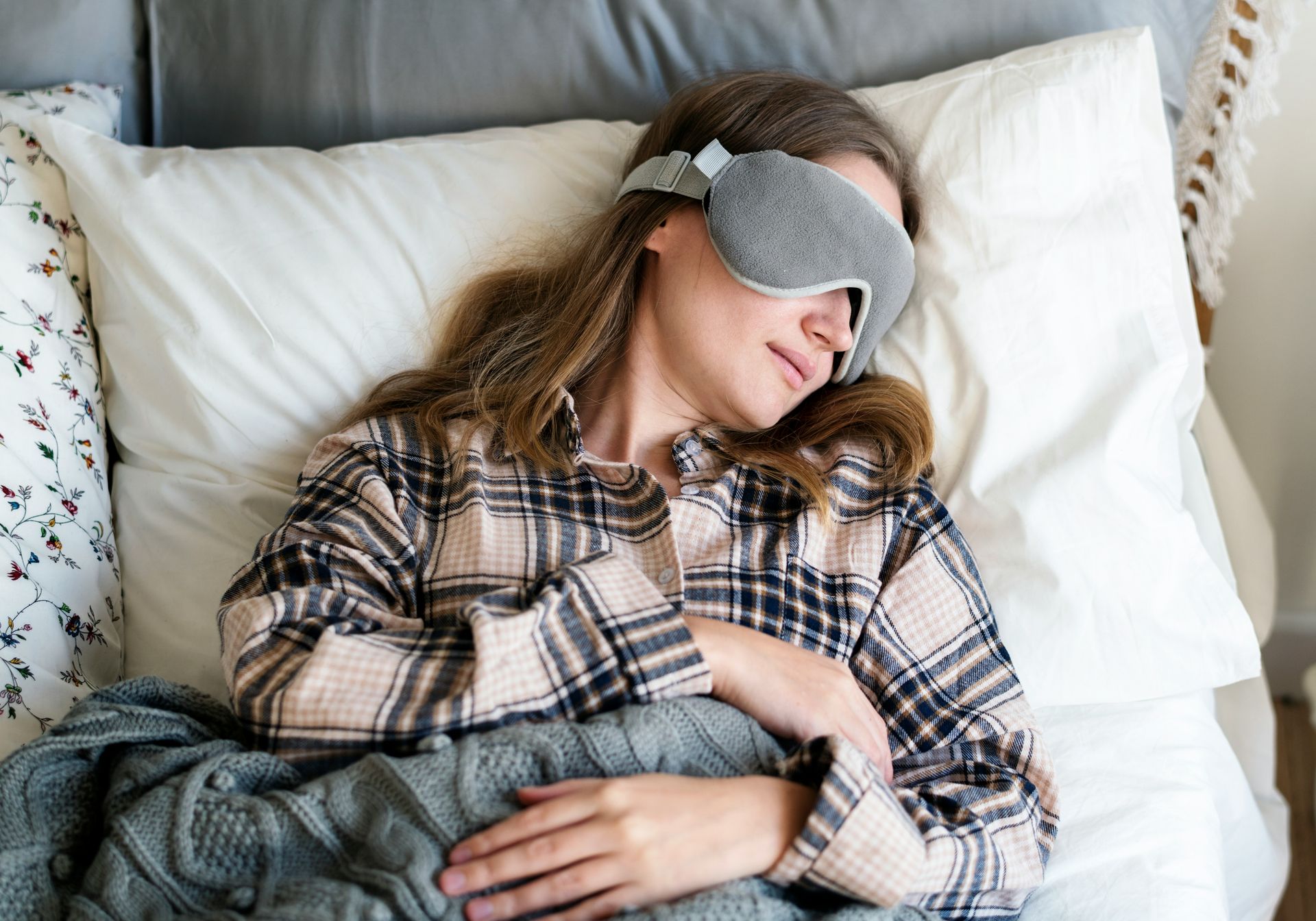 woman sleeping in pajamas with sleepmask