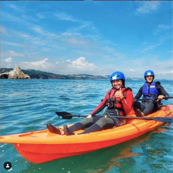 A couple pose for a photo in a Fatyak Mahee tandem kayak