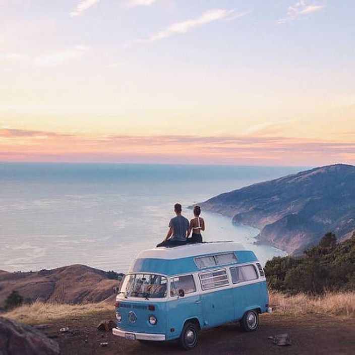 Couple on top of a Volkswagen van