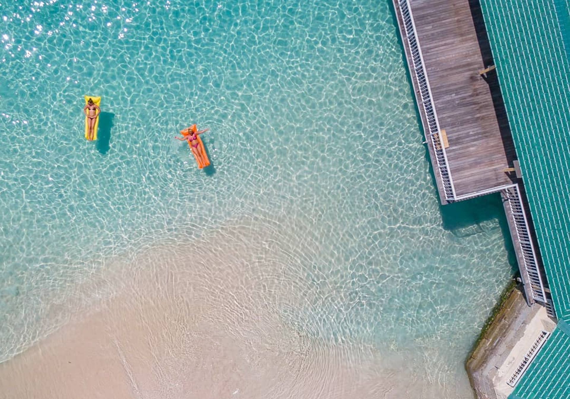 women floating in clear sea