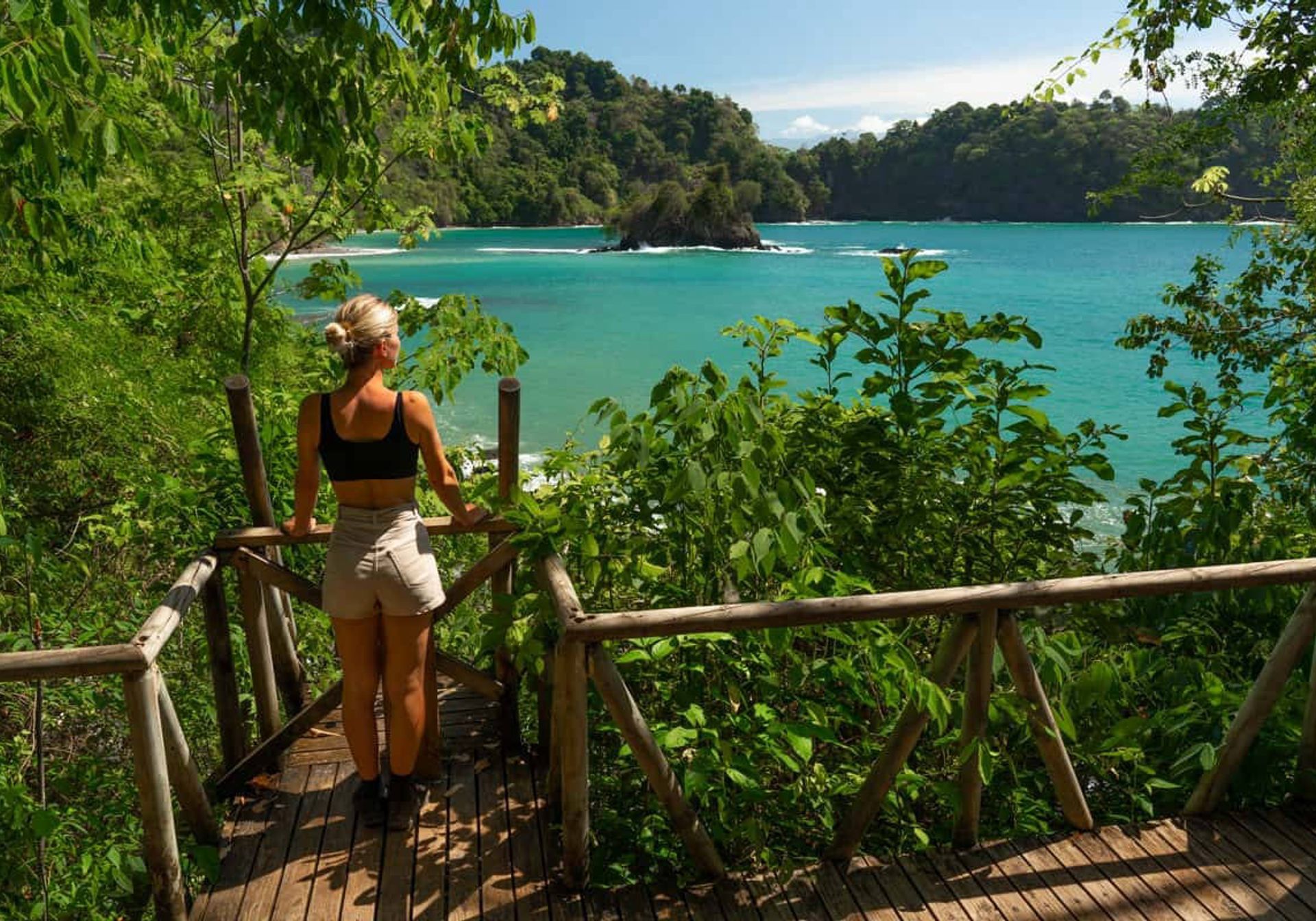 A girl looks out at Manuel Antonio National Park beach