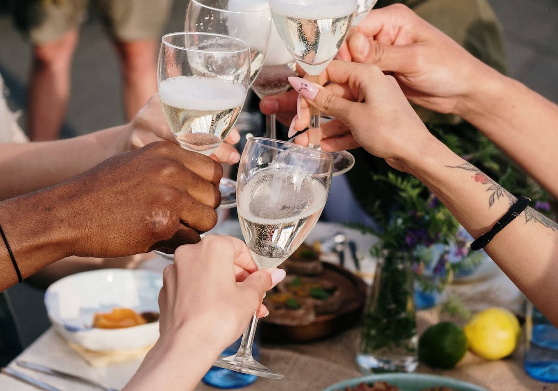 Friends toasting glasses of Prosecco at breakfast 
