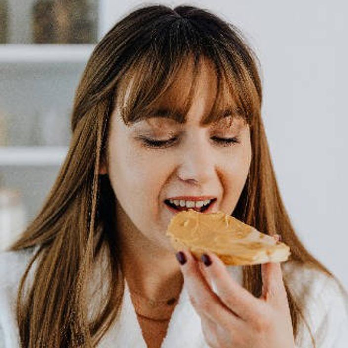 nut butter being spread on bread