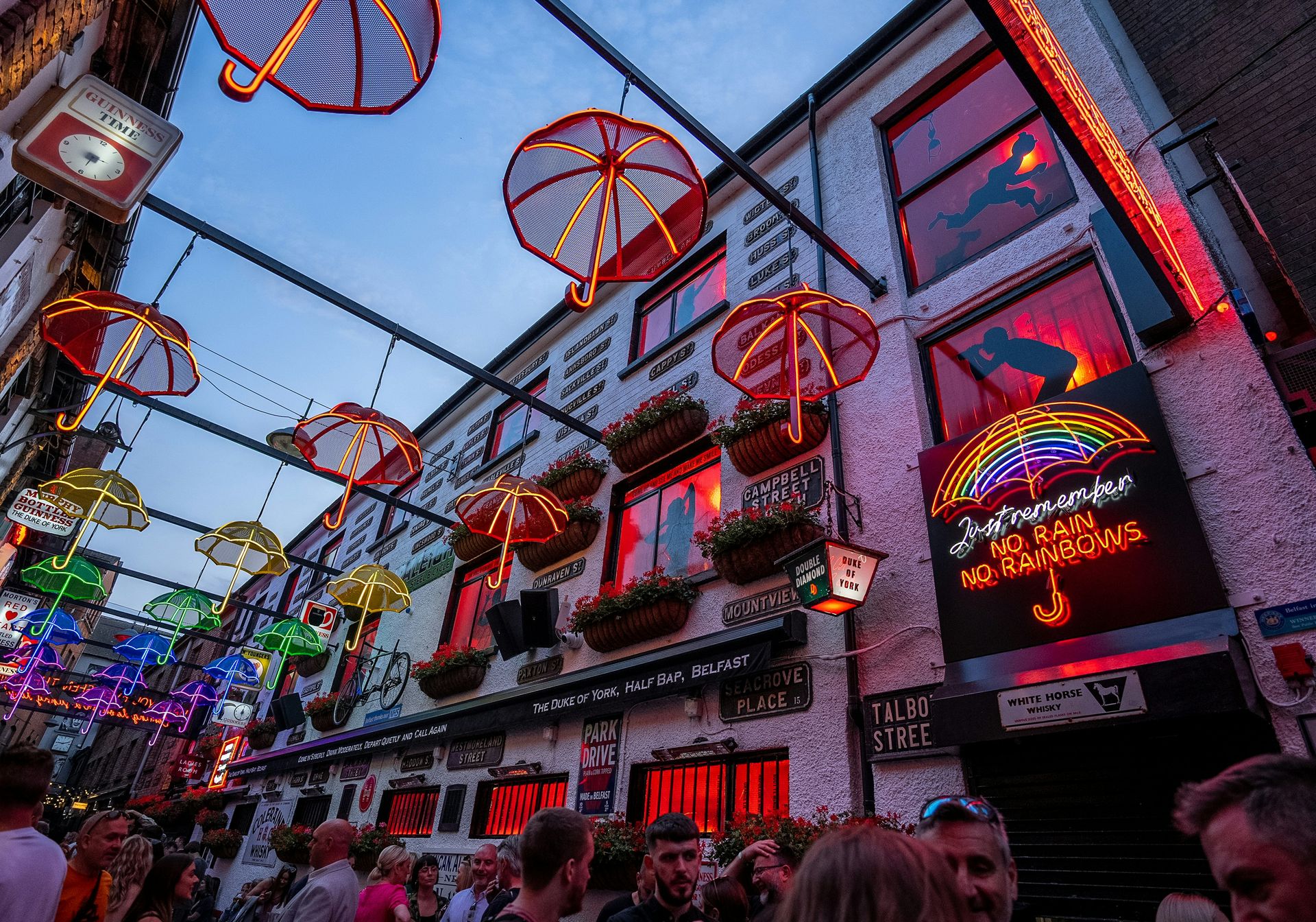 Belfast alley with illuminated neon umbrellas hanging overhead