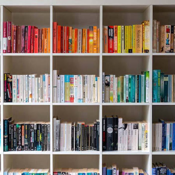Bookshelf with books organised by colour