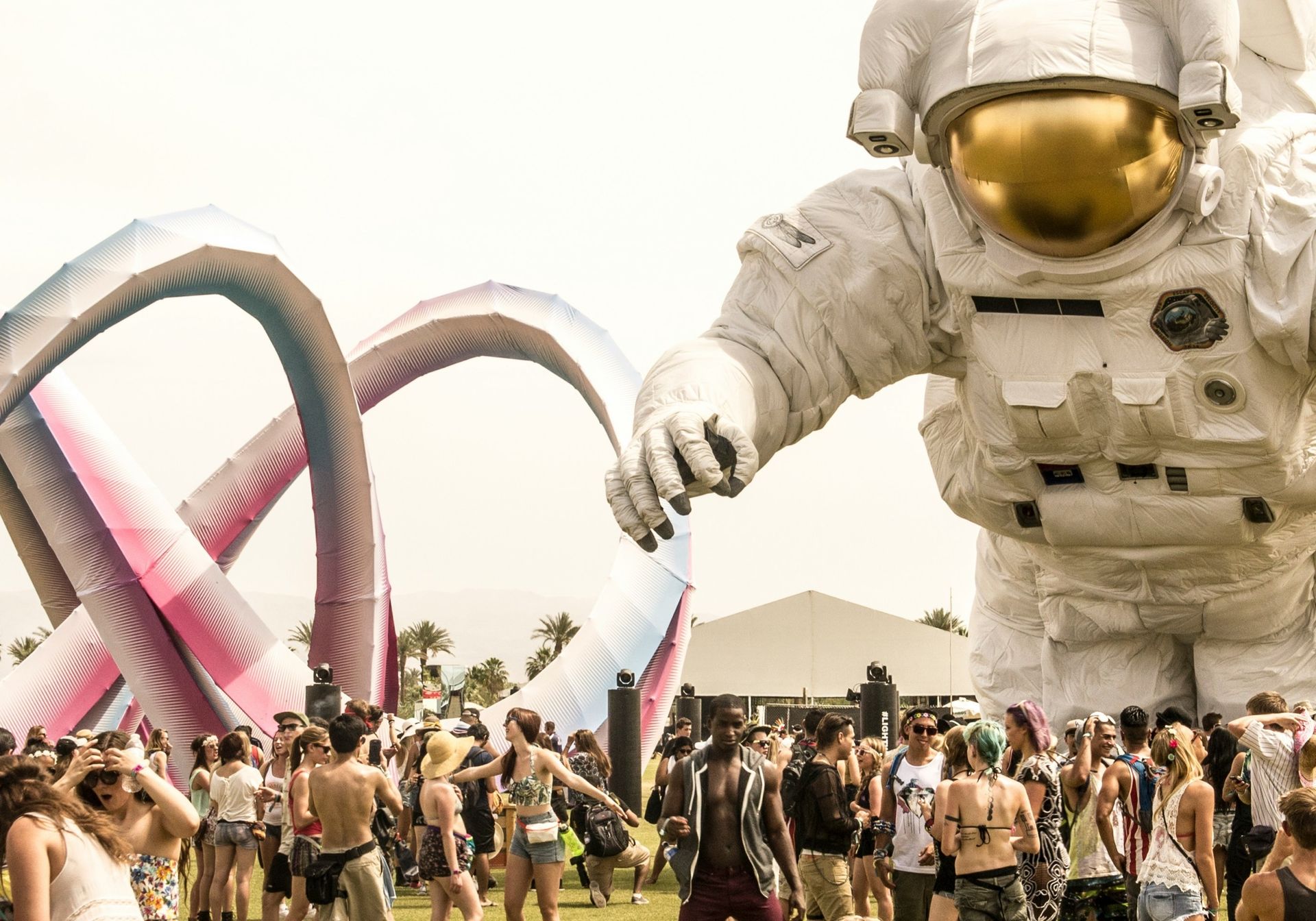 photo of an inflated astronaut overlooking a festival scene