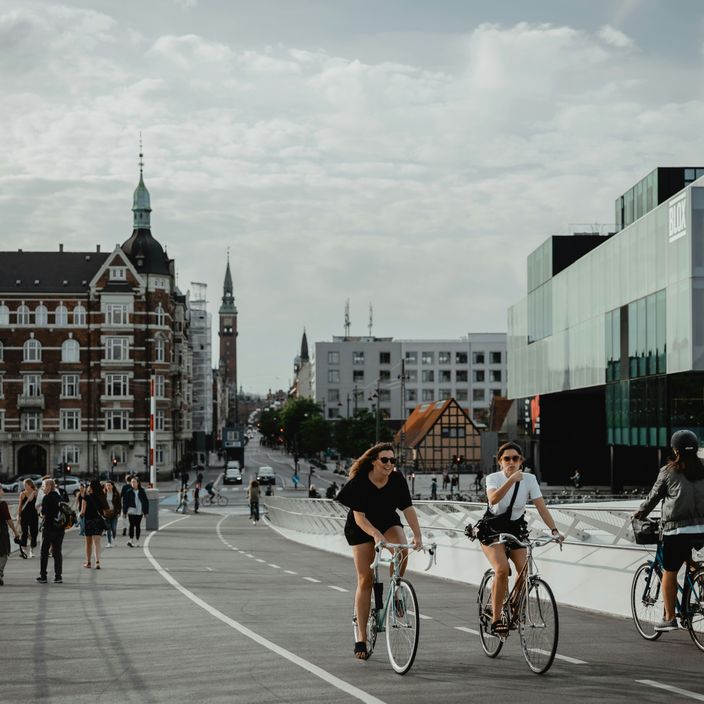 A couple sitting by the water in Copenhagen