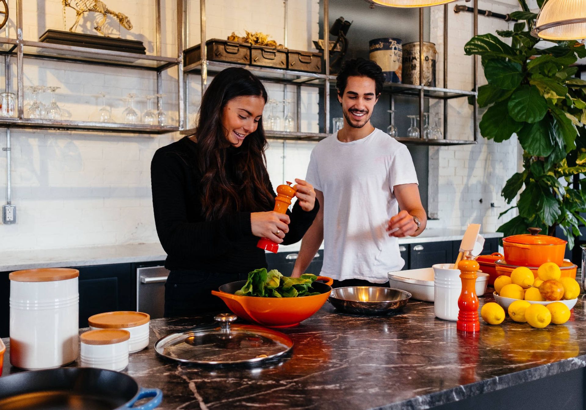 Couple making food in a bright kitchen