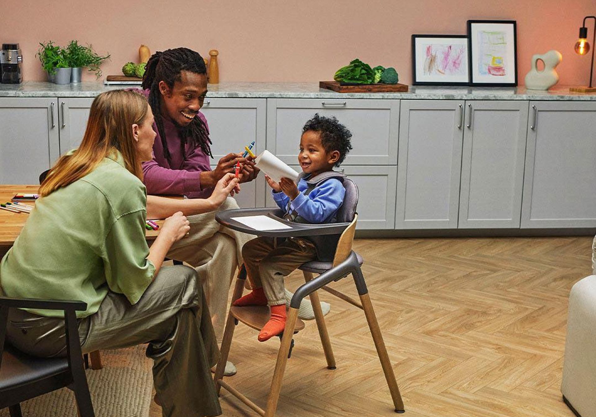Couple with their child in a Bugaboo giraffe high chair