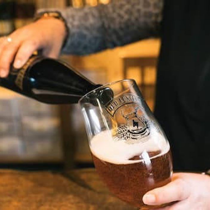 A man pouring a beer into a glass
