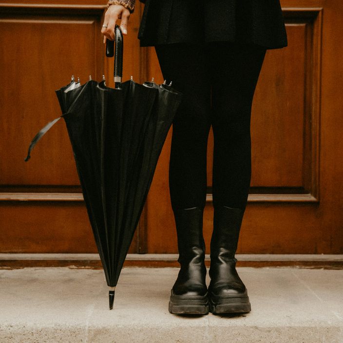 feet and umbrella in a doorstep