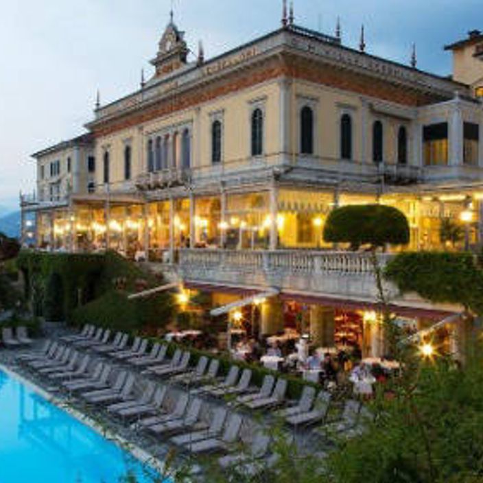 a bench overlooking lake como on a sunny day