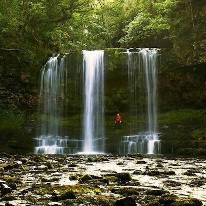 Person hiking around waterfalls