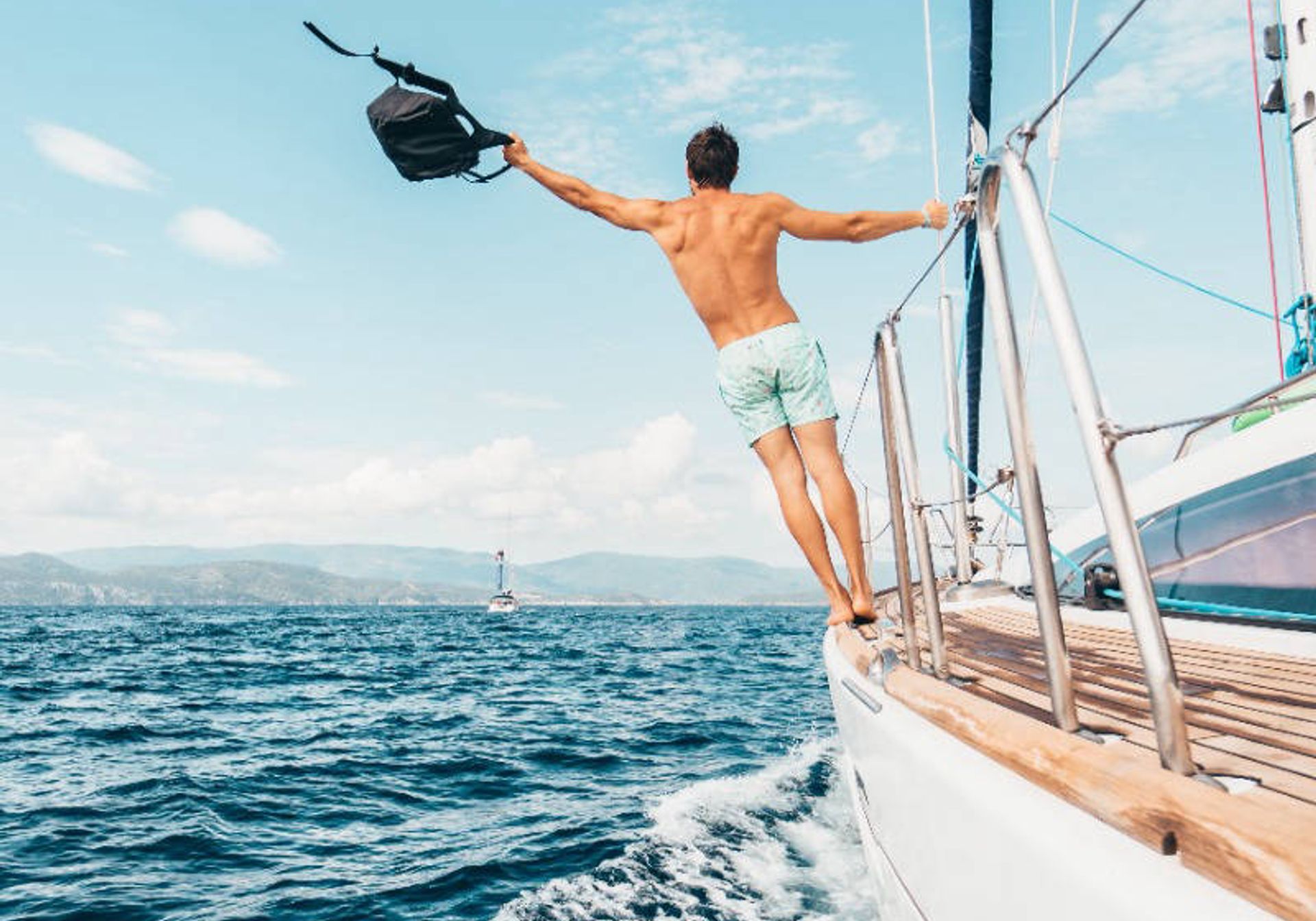 Man on a yacht on blue waters